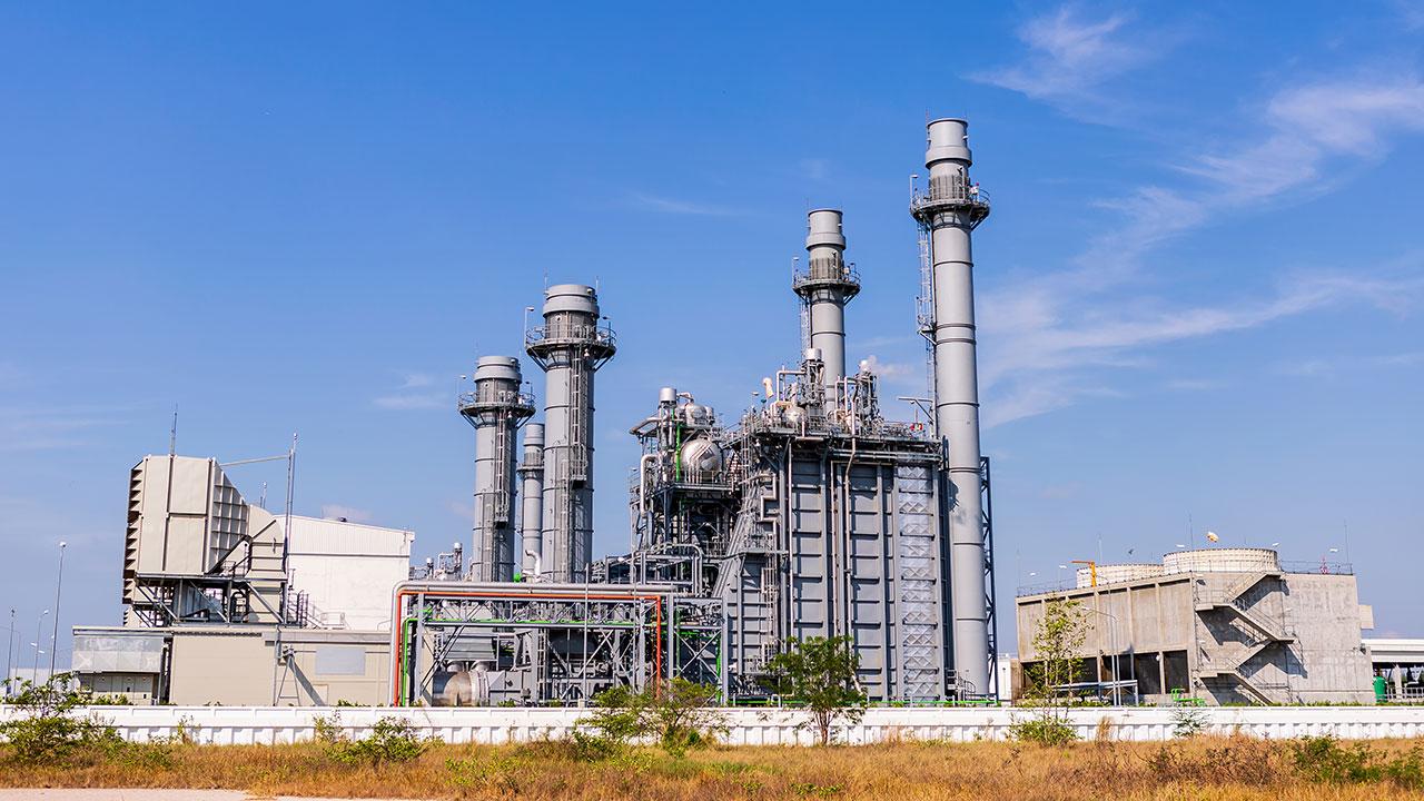 Combined cycle power plant against a blue sky